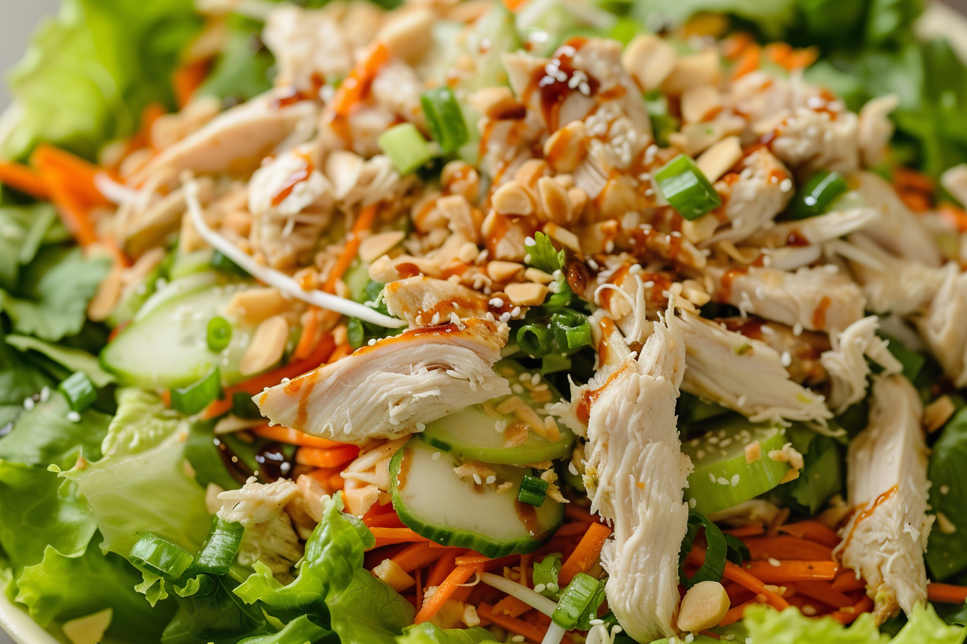 Fresh Mandarin Chicken Crunch Salad with grilled chicken breast, napa cabbage, romaine, mandarin oranges, edamame, toasted almonds, crispy wonton strips, and a house-made sesame dressing.
