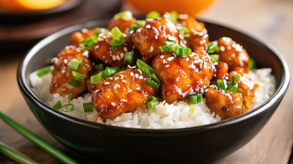 Homemade Orange Chicken Bowl with basmati rice and seasonal vegetables served in a meal prep container.